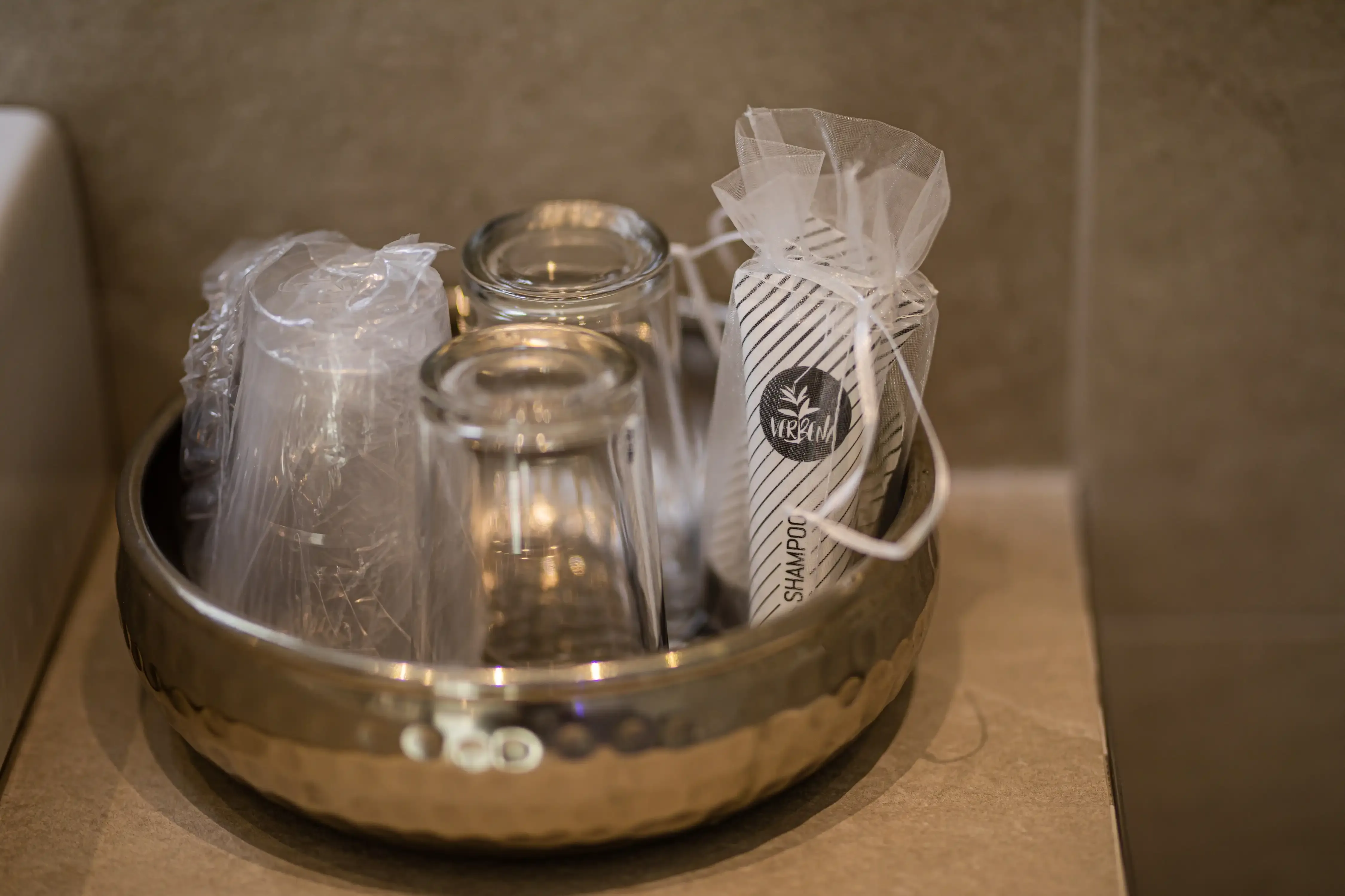 Bicchieri e shampoo in omaggio in un bagno d'albergo