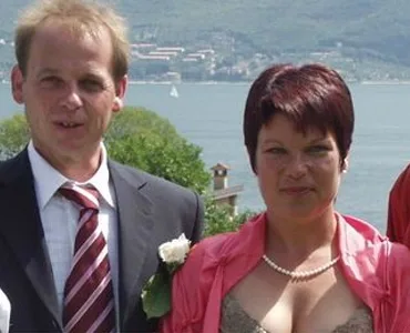 Coppia elegante posano vicino a un lago durante un matrimonio