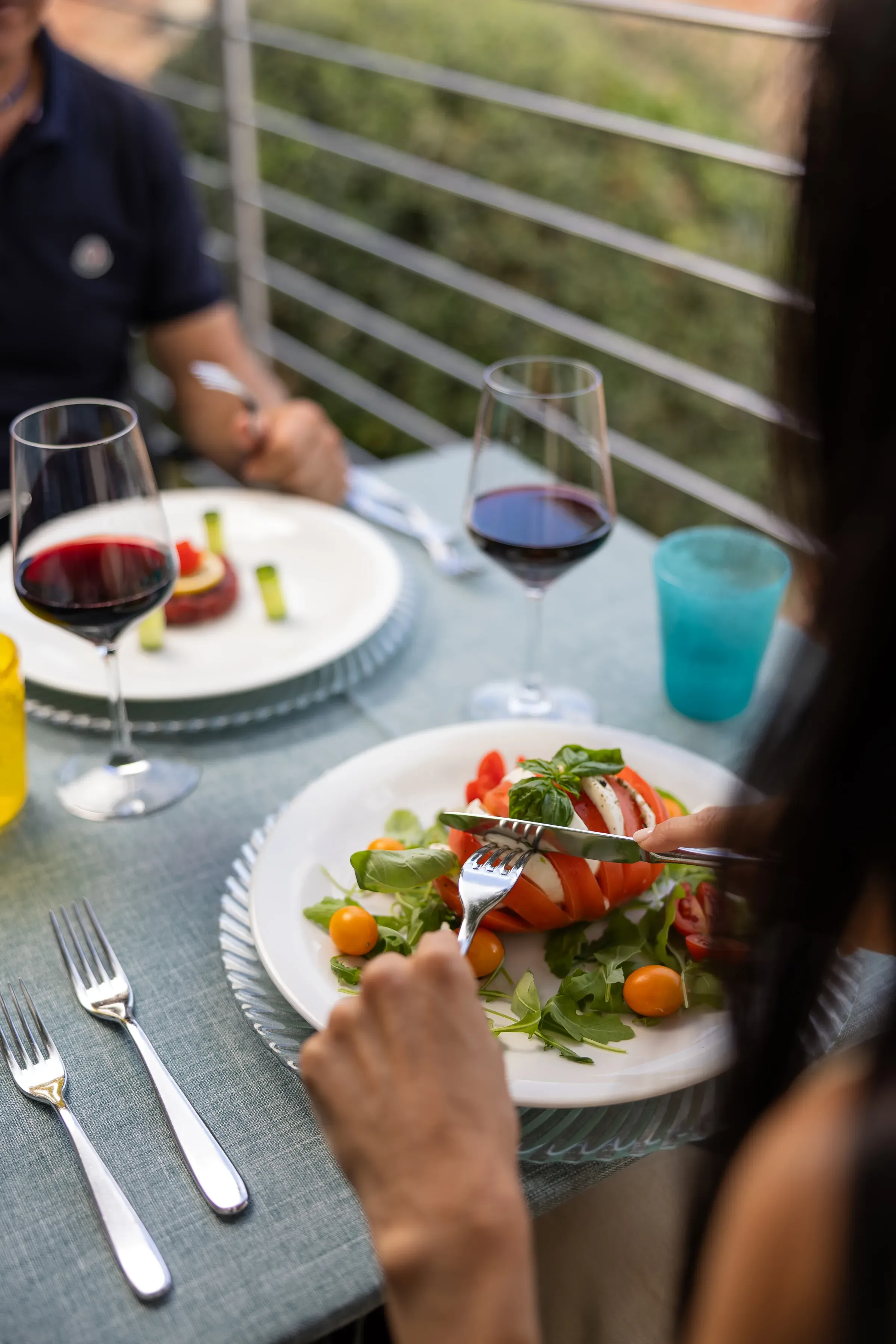 Insalata caprese con pomodori e mozzarella servita con vino rosso