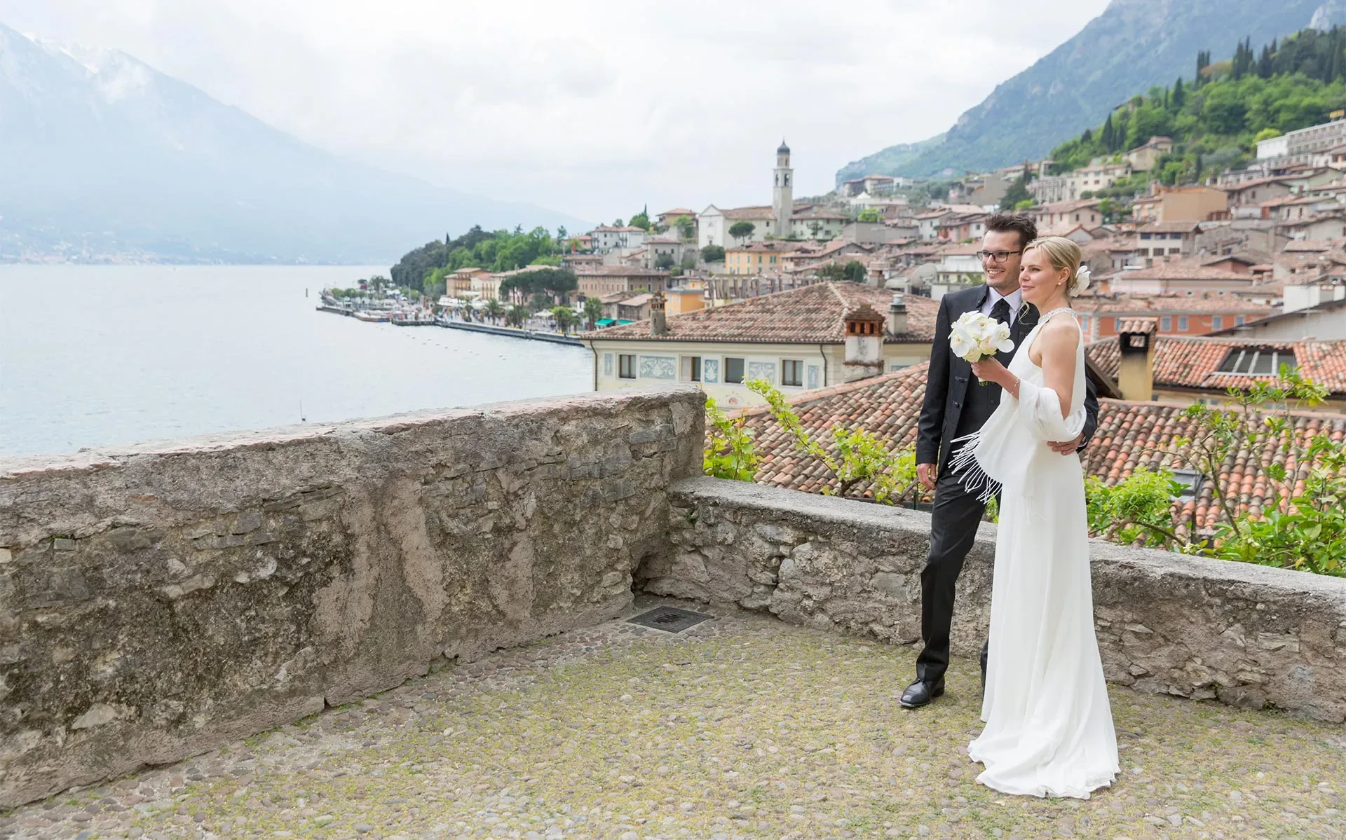 Coppia di sposi in posa con vista panoramica sul Lago di Como